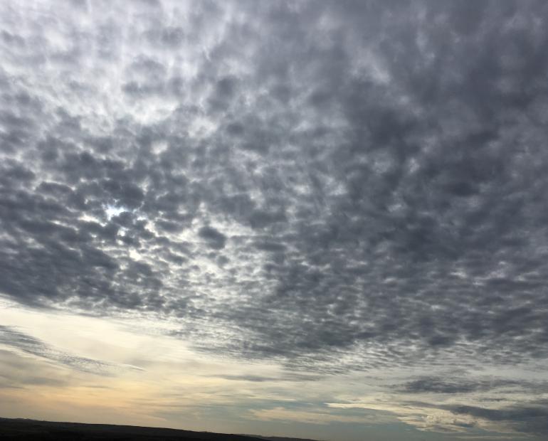 An image of a moody sky with mottled clouds