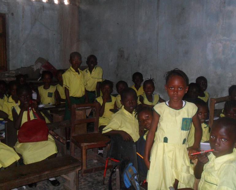 African schoolchildren in the classroom gazing at the camera.