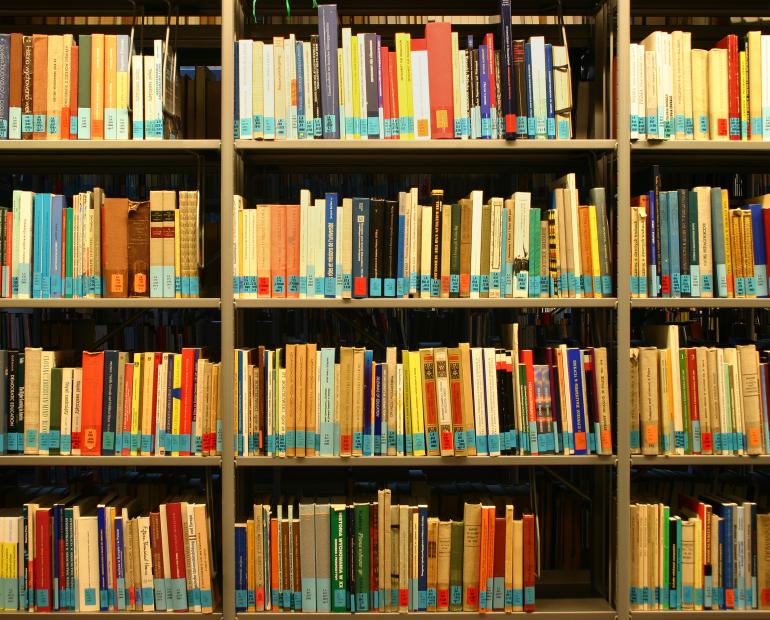 Library, full of books in a book shelf 