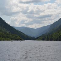 A view over a lake, with mountains in the back in a beautiful summer afternoon. 