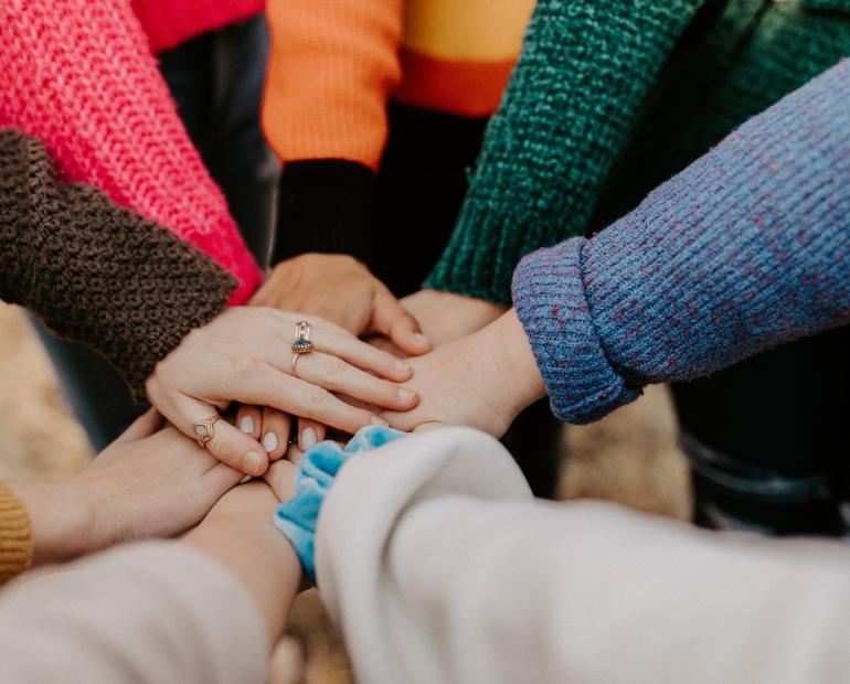 A picture of hands one on top of each other in solidarity. 