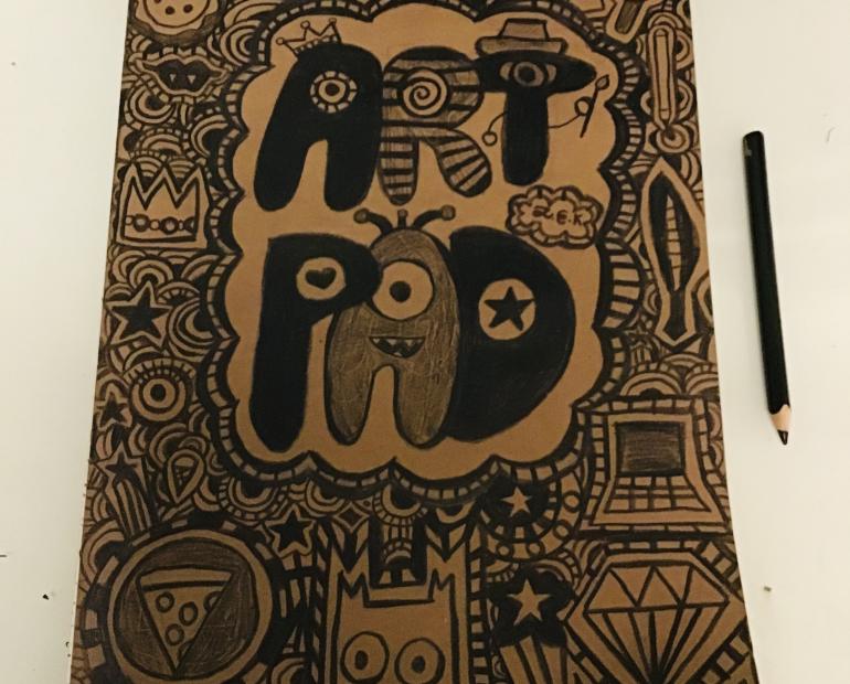 This is my art pad. The cover was plain cardboard at first, thus I decided to decorate it with doodles I did.