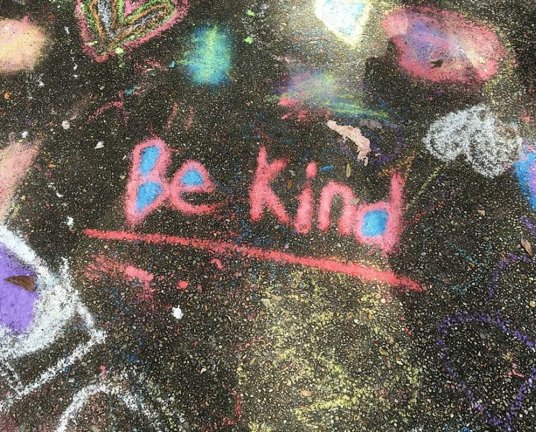 "Be Kind" written in chalk