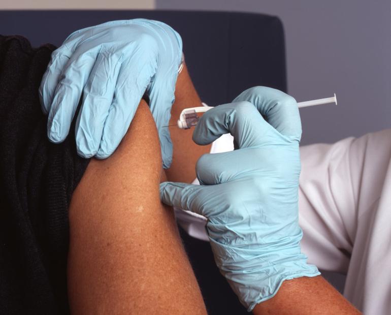 A person's arm receiving a vaccine