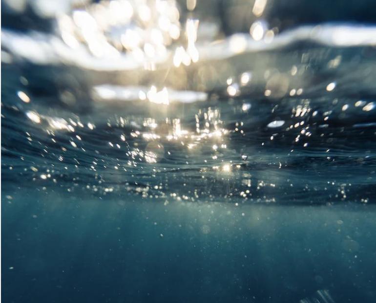 The sunlight as seen from under water in the sea.