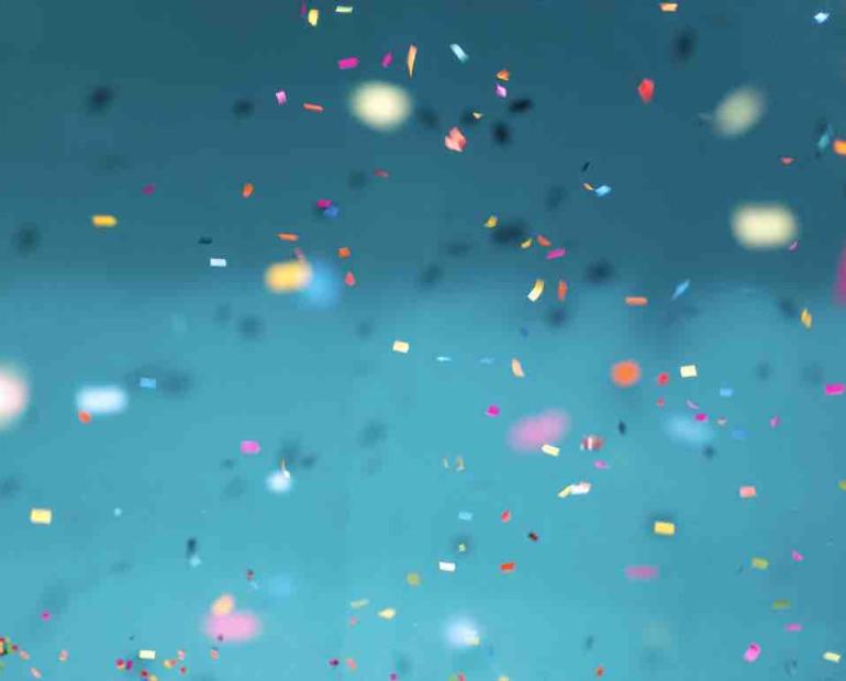 Confetti over a blue background.