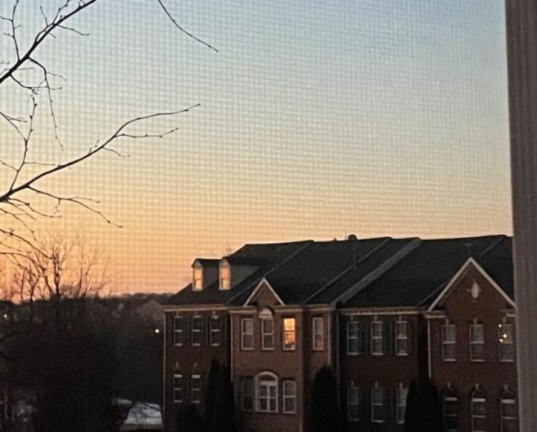 sunset reflecting in the windows of nearby houses.