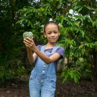 Maria poses in a garden.