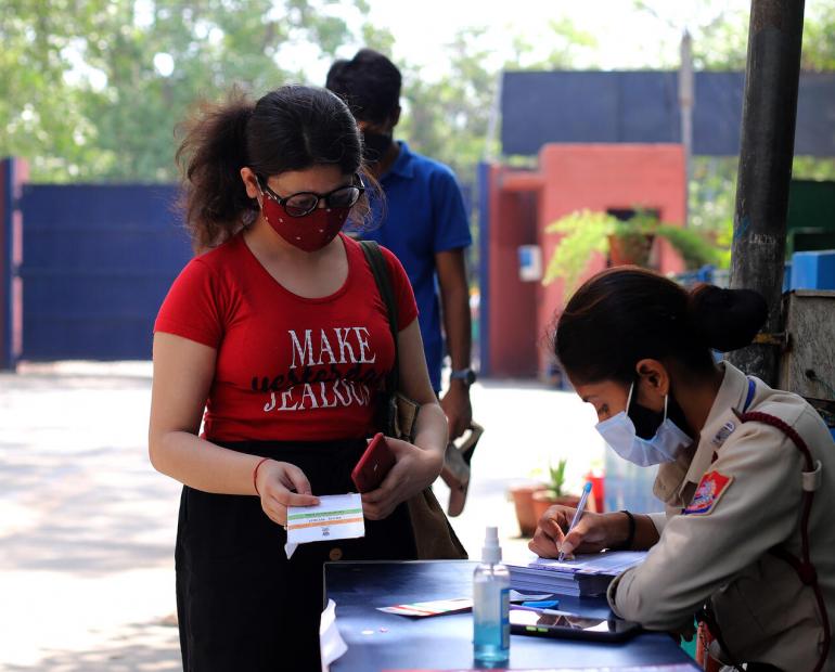 woman in queue to receive a dose of the COVID-19 vaccine