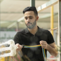 Abdu is watering plants.