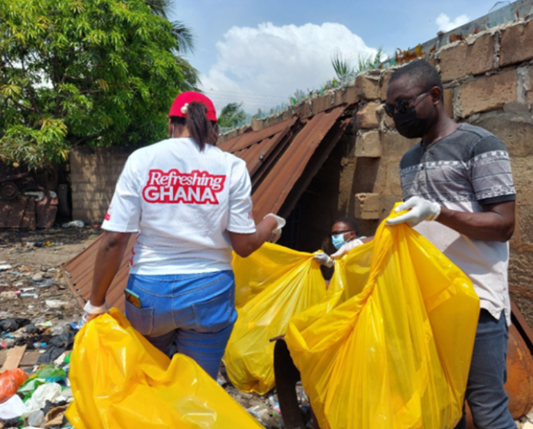 Two young people are picking up trash.